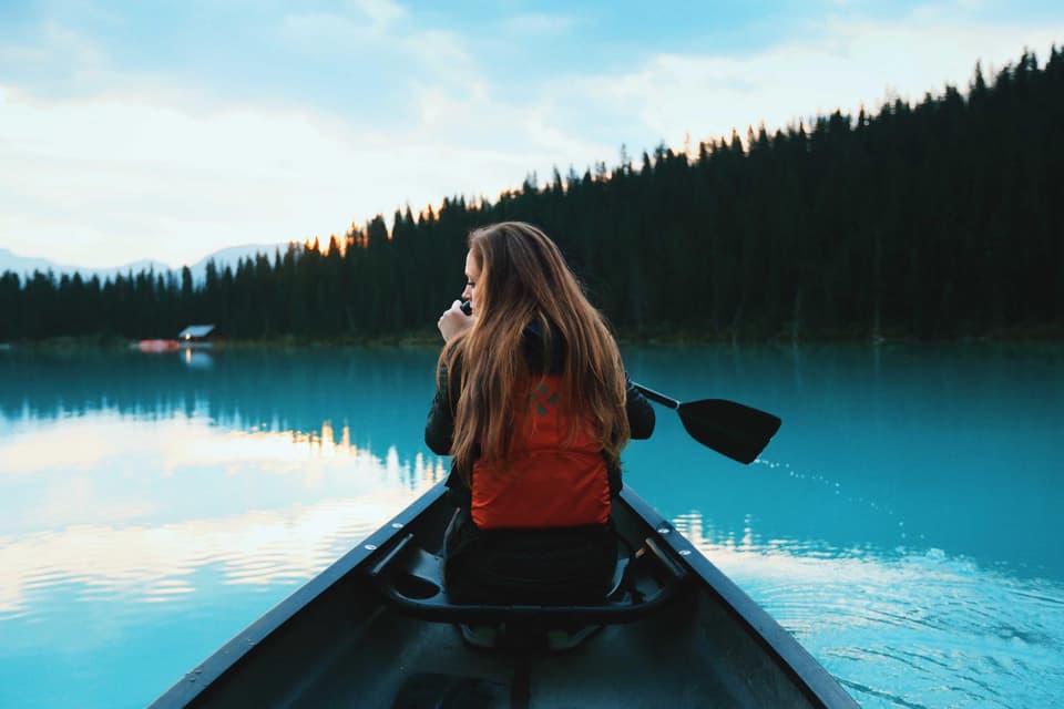 Canoe on a still lake at dawn